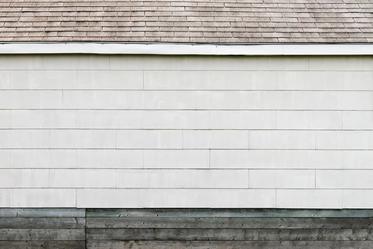 Lap siding and shingle roofline on a finished home